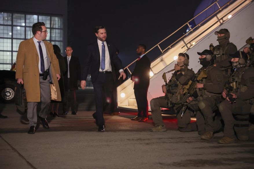 U.S. Vice President J.D. Vance walks next to German law enforcement personnel before boarding Air Force Two for travel back to Washington from Munich International Airport in Munich, Germany, Friday, Feb.14, 2025. (Leah Millis/Pool Photo via AP)