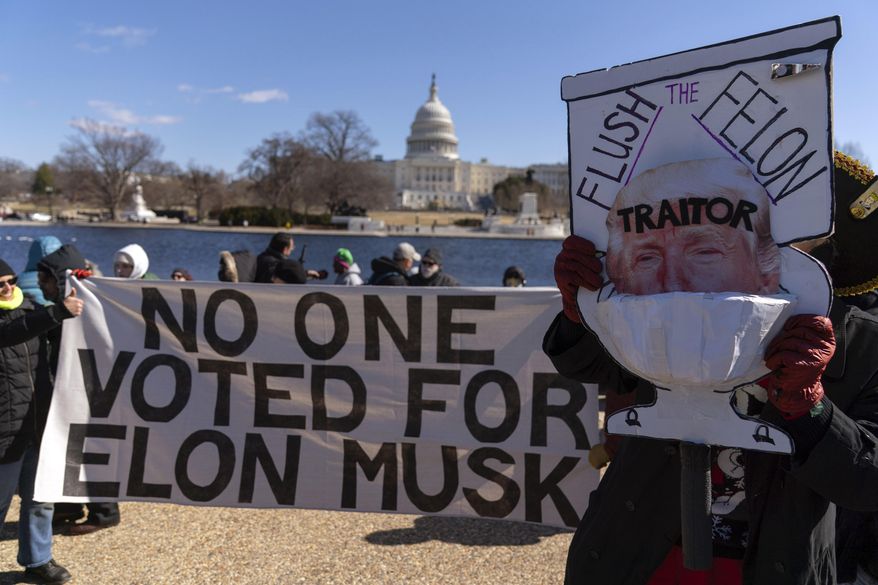 Demonstrators rally during the "No Kings Day" protest on Presidents Day in Washington, in support of federal workers and against recent actions by President Donald Trump and Elon Musk, on Capitol Hill in Washington Monday, Feb. 17, 2025. (AP Photo/Jose Luis Magana)