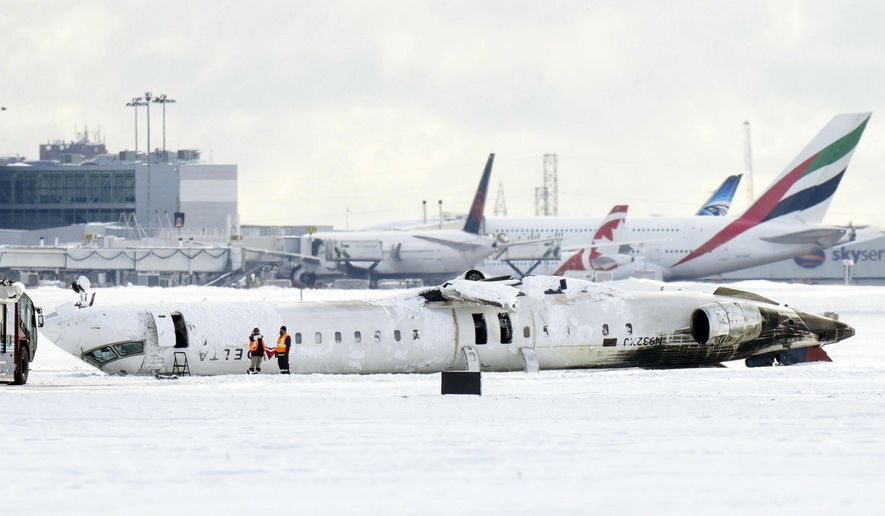 A Delta Air Lines plane lies upside down at Toronto Pearson Airport on Tuesday, Feb. 18, 2025. (Chris Young/The Canadian Press via AP)