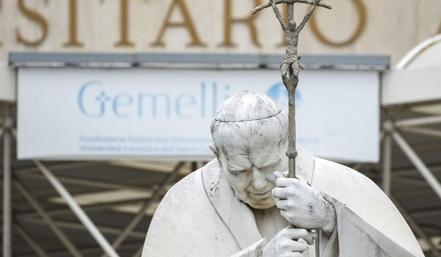 A statue of Pope John Paul II is seen in front of the Agostino Gemelli Polyclinic, in Rome, Tuesday, Feb. 18, 2025, where Pope Francis has been hospitalised to undergo some necessary diagnostic tests and to continue his ongoing treatment for bronchitis. (AP Photo/Andrew Medichini)