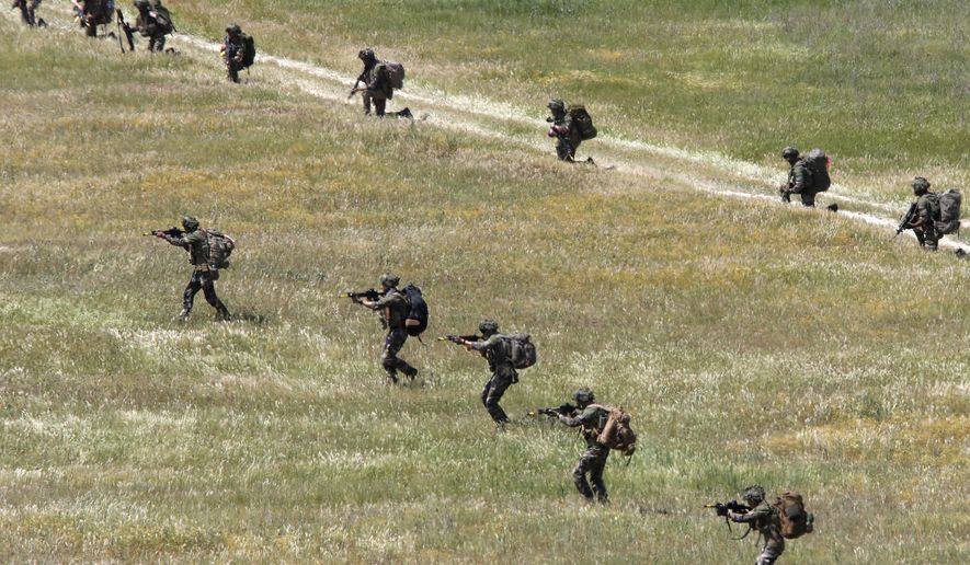 British soldiers from the 16 Air Assault Brigade take part in the Swift Response 22 military exercise at the Krivolak army training polygon in the central part of North Macedonia, on Thursday, May 12, 2022. Hundreds of NATO soldiers have presented on Thursday airborne operations followed by parachuting, helicopters and ground activities to the top country's officials and diplomats, as allied airborne forces exercise "Swift Response 22" has entered in its final phase at the military polygon "Krivolak" in North Macedonia. The exercise, that includes about 4,600 soldiers from Albania, France, Greece, Italy, North Macedonia, Montenegro, the UK, and the U.S., was to demonstrate the NATO states' ability to deploy anywhere around the world and that it's soldiers can operate together professionally and successfully. (AP Photo/Boris Grdanoski)