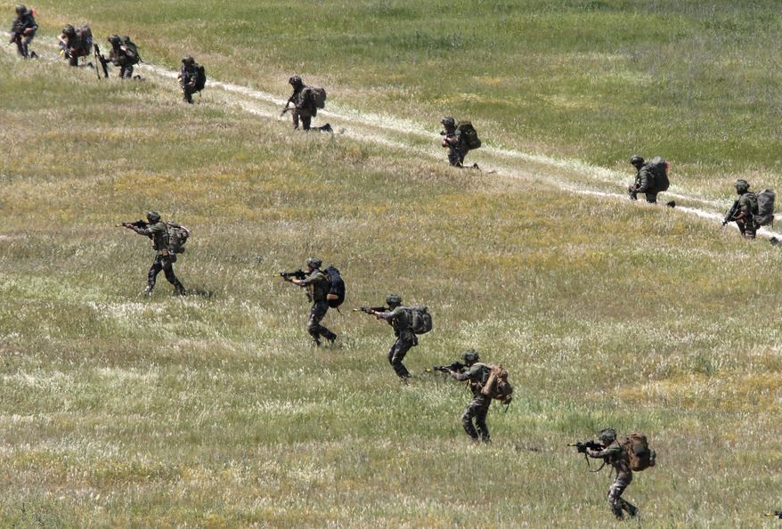 British soldiers from the 16 Air Assault Brigade take part in the Swift Response 22 military exercise at the Krivolak army training polygon in the central part of North Macedonia, on Thursday, May 12, 2022. Hundreds of NATO soldiers have presented on Thursday airborne operations followed by parachuting, helicopters and ground activities to the top country's officials and diplomats, as allied airborne forces exercise "Swift Response 22" has entered in its final phase at the military polygon "Krivolak" in North Macedonia. The exercise, that includes about 4,600 soldiers from Albania, France, Greece, Italy, North Macedonia, Montenegro, the UK, and the U.S., was to demonstrate the NATO states' ability to deploy anywhere around the world and that it's soldiers can operate together professionally and successfully. (AP Photo/Boris Grdanoski)