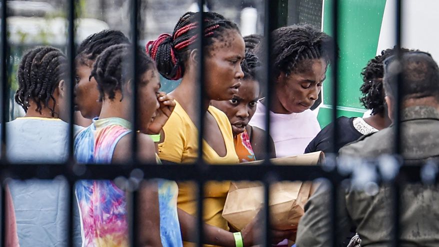 FILE - Migrants prepare to depart the U.S. Customs and Border Protection - Marathon Border Patrol Station in Marathon, Fla., June 26, 2024. A group of more than 100 migrants from Haiti arrived off Key West in a sailboat early Wednesday morning, according to the Monroe County Sheriff's Office. (Al Diaz/Miami Herald via AP, File)