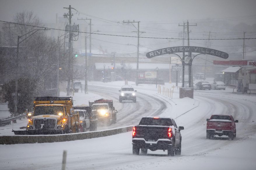 Snow plows make their way up the Granby Street bridge in Norfolk, Va., on Wednesday, Feb. 19, 2025. (Kendall Warner/The Virginian-Pilot via AP) ** FILE **