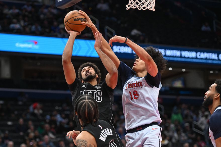 Washington Wizards forward Kyshawn George (18) blocking a shot by Brooklyn Nets forward Cameron Johnson (2) during the fourth quarter of an NBA game at Capital One Arena in Washington D.C., February 24, 2025. (Photo for the Washington Times)