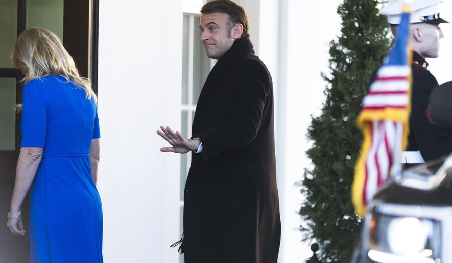 French President Emmanuel Macron is escorted by Chief of Protocol Monica Crowley as he arrives at the White House, Monday, Feb. 24, 2025, in Washington. (AP Photo/Manuel Balce Ceneta)