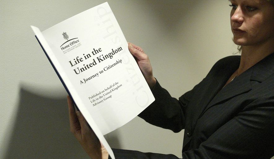 A woman holds a copy of the 'Life in the United Kingdom' book aimed at assisting applicants to pass the 'Life in the UK test' at the British Museum in central London, Oct, 31, 2005. (AP Photo/Sergio Dionisio, File)