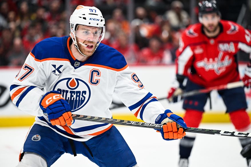 Edmonton Oilers center Connor McDavid (97) attempts to bat the puck out of the air with his stick against the Washington Capitals at Capital One Arena, Washington, D.C., February 23, 2025. (Photo by Brian Murphy for the Washington Times)