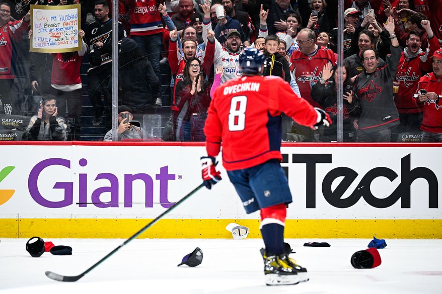 Washington Capitals left wing Alex Ovechkin (8) skates over to his son, Sergei, after completing the 32nd hat trick of his distinguished career in a 7-3 rout of the Edmonton Oilers at Capital One Arena, Washington, D.C., February 23, 2025. (Photo by Brian Murphy for the Washington Times)