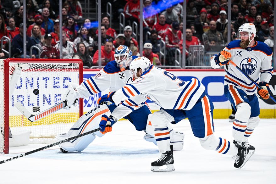Edmonton Oilers goalie Calvin Packard (30) and center Connor McDavid (97) cannot prevent a first period goal by Washington Capitals right wing Tom Wilson (43) at Capital One Arena, Washington, D.C., February 23, 2025. (Photo by Brian Murphy for the Washington Times)