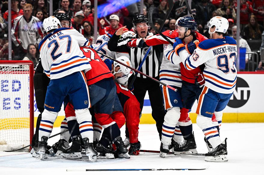 Washington Capitals right wing Taylor Raddysh (16) needs to be separated from Edmonton Oilers left wing Viktor Arvidsson (33) after he took a cheap shot on Washington Capitals center Nic Dowd (26) at Capital One Arena, Washington, D.C., February 23, 2025. (Photo by Brian Murphy for the Washington Times)