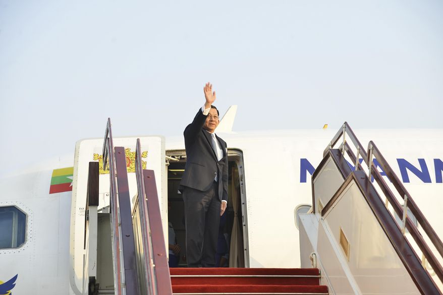 In this image provided by The Myanmar Military True News Information Team, Myanmar's military leader Senior Gen. Min Aung Hlaing waves as he departs from Naypyidaw international airport, Myanmar to Russia Monday, March 3, 2025. (The Myanmar Military True News Information Team via AP)