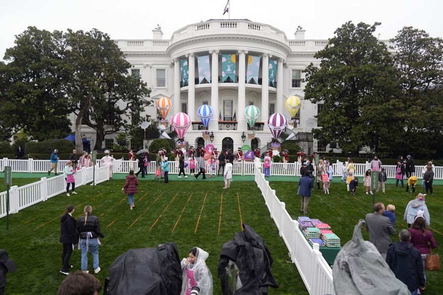 The White House Easter Egg Roll is set to begin on the South Lawn of the White House in Washington, Monday, April 1, 2024. Thunder and lightning delayed the start of the Easter egg roll at the White House for 90 minutes on Monday, but the event eventually kicked off under gray skies and internment rain. More than 40,000 people, 10,000 more than last year, were expected to participate in the event. (AP Photo/Mark Schiefelbein)