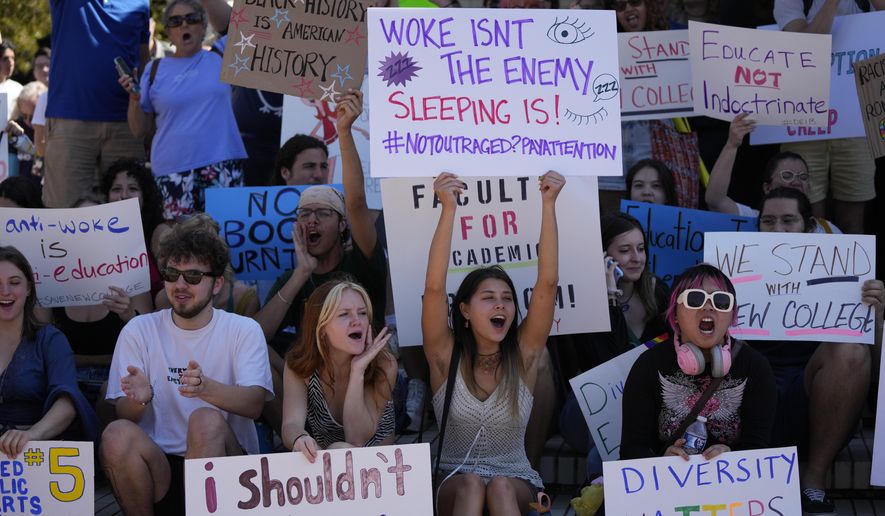 FILE - New College of Florida students and supporters protest ahead of a meeting by the college's board of trustees, Feb. 28, 2023, in Sarasota, Fla. The conservative-dominated board of trustees of Florida's public honors college was meeting to take up a measure making wholesale changes in the school's diversity, equity and inclusion programs and offices. (AP Photo/Rebecca Blackwell, File)