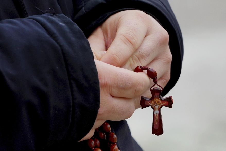 A man holds rosary beads as he prays for Pope Francis in front of the Agostino Gemelli Polyclinic, where the Pontiff has been hospitalized since Feb. 14, in Rome, Wednesday, Feb. 26, 2025. (AP Photo/Kirsty Wigglesworth)