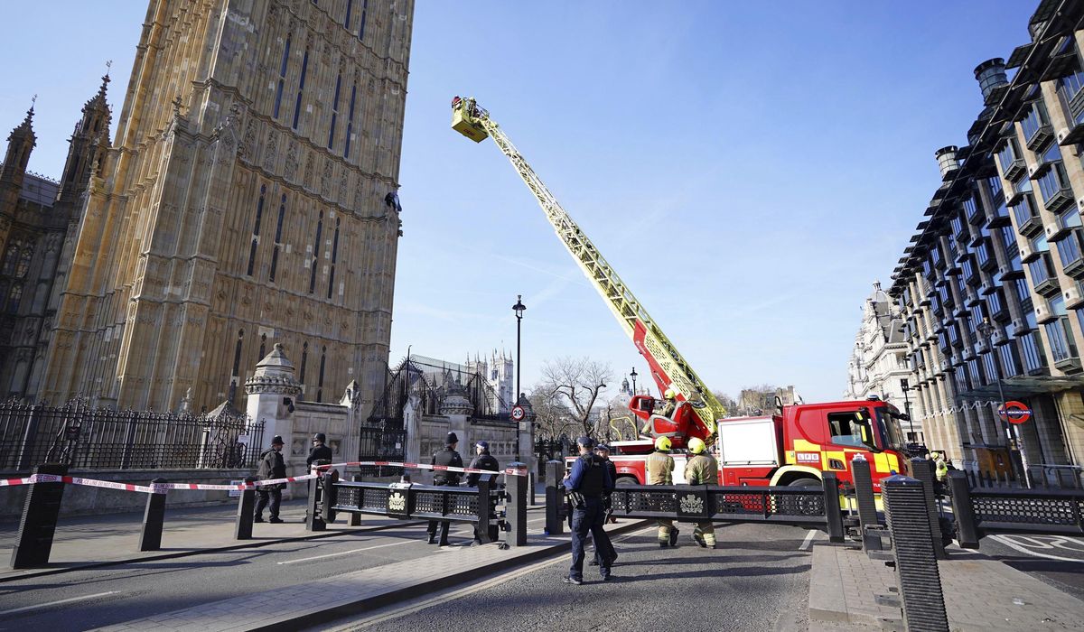 NextImg:Emergency services respond after a man with a Palestinian flag climbs up Big Ben tower