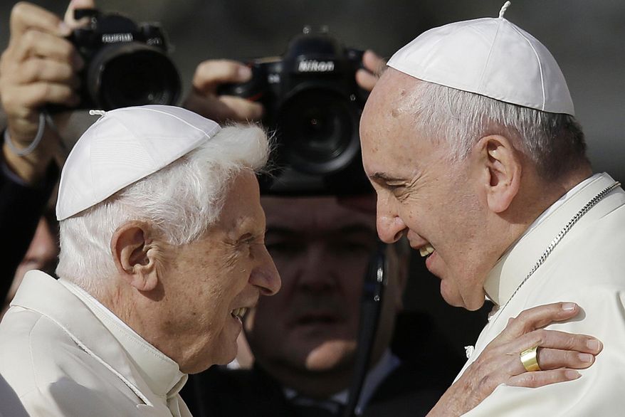 Pope Francis, right, hugs Emeritus Pope Benedict XVI prior to the start of a meeting with elderly faithful in St. Peter's Square at the Vatican on Sept. 28, 2014. (AP Photo/Gregorio Borgia, File)
