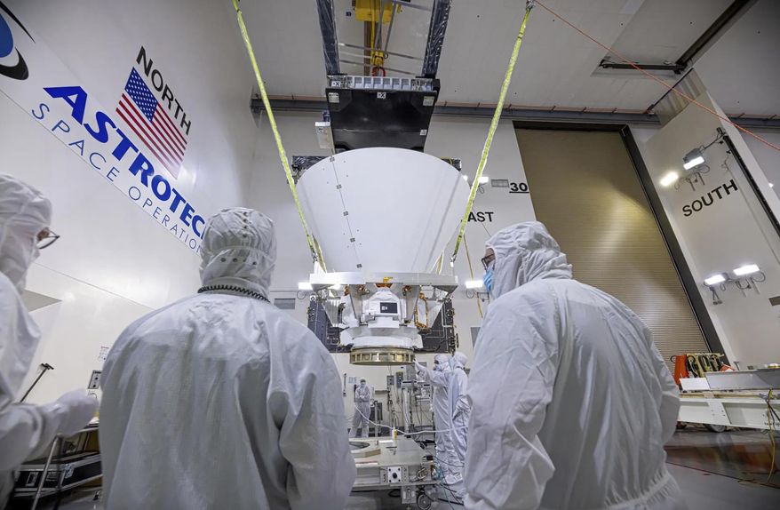 This image provided by NASA shows BAE Systems employees working on NASA’s SPHEREx observatory in the Astrotech Space Operations facility at Vandenberg Space Force Base in California on Jan. 16, 2025. (NASA via AP) ** FILE **