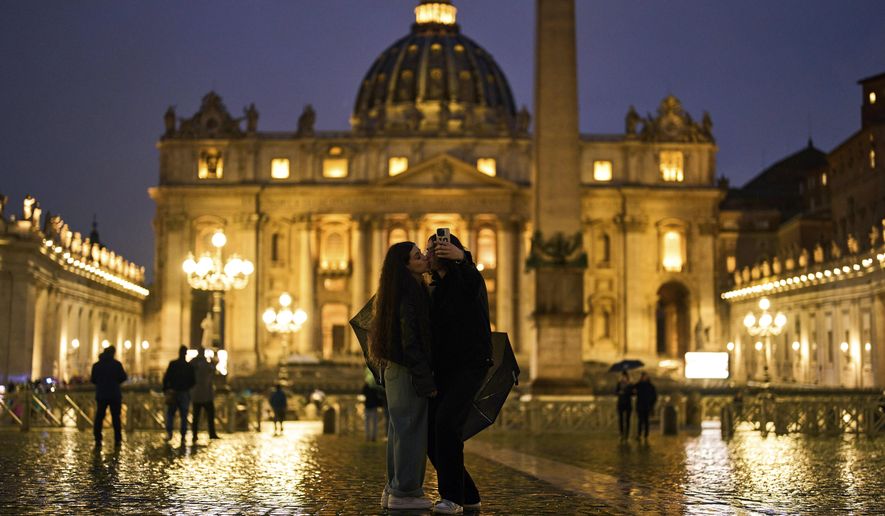 A couple kiss in St. Peter's Square at The Vatican, Wednesday, March 12, 2025. (AP Photo/Francisco Seco)