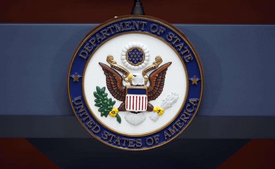 The seal of the State Department is seen at the Washington Passport Agency, July 12, 2016, in Washington. (AP Photo/Alex Brandon, File)