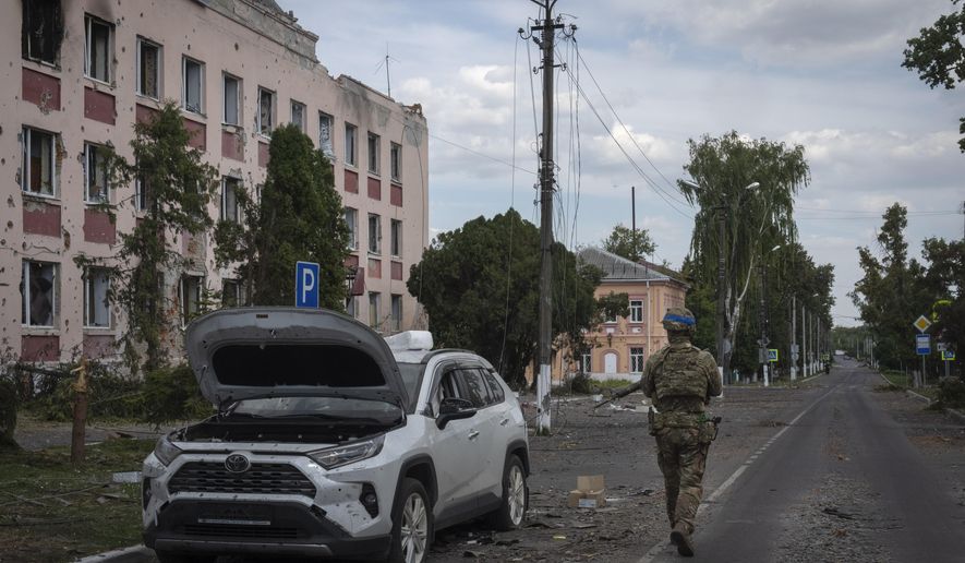 A Ukrainian soldier walks past at a city hall in Sudzha, Kursk region, Russia, Friday, Aug. 16, 2024. This image was approved by the Ukrainian Defense Ministry before publication. (AP Photo, File)