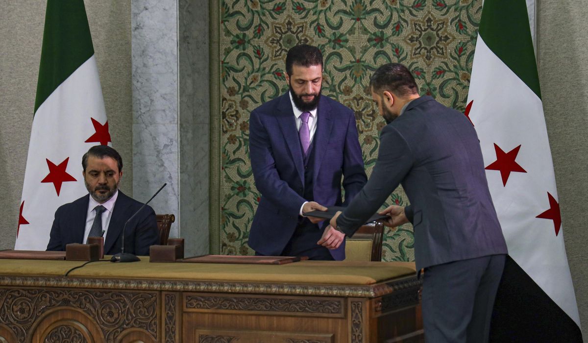 NextImg:Syrian leader signs constitution that puts the country under an Islamist group’s rule for 5 years
