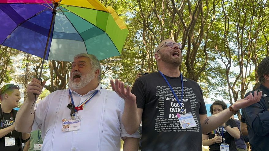 FILE - The Rev. David Meredith, left, and the Rev. Austin Adkinson sing during a gathering of those in the LGBTQ community and their allies outside the Charlotte Convention Center, in Charlotte, N.C., Thursday, May 2, 2024. (AP Photo/Peter Smith, File)