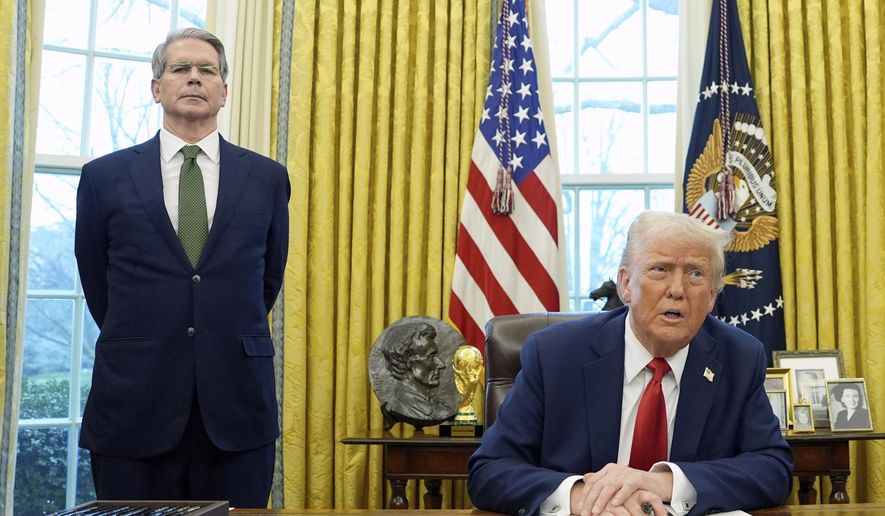 President Donald Trump speaks as Treasury Secretary Scott Bessent listens as Trump prepares to sign an executive order in the Oval Office of the White House, Feb. 3, 2025, in Washington. (AP Photo/Evan Vucci, File)