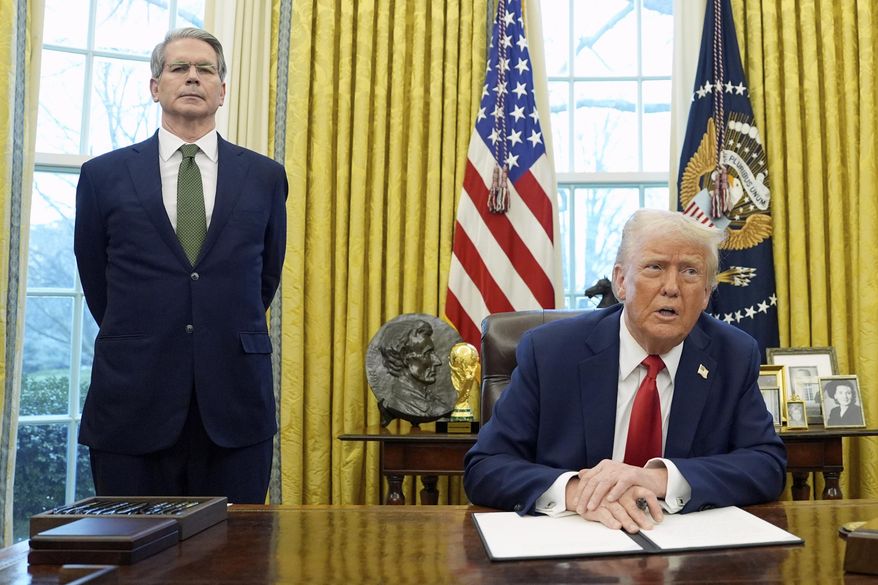President Donald Trump speaks as Treasury Secretary Scott Bessent listens as Trump prepares to sign an executive order in the Oval Office of the White House, Feb. 3, 2025, in Washington. (AP Photo/Evan Vucci, File)