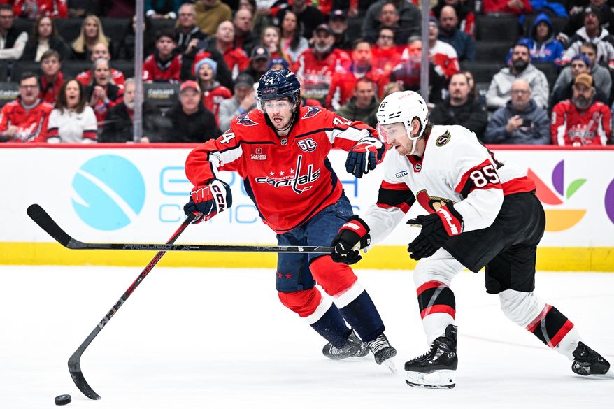 Washington Capitals center Connor McMichael (24) tries to poke the puck away from Ottawa Senators defenseman Jake Sanderson (85) at Capital One Arena, Washington, D.C., March 3, 2025. (Photo by Brian Murphy for the Washington Times)