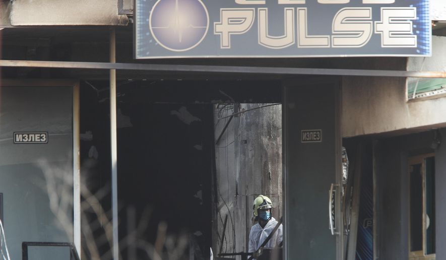 A firefighter inspects a nightclub after a massive fire in the town of Kocani, North Macedonia, Sunday, March 16, 2025. (AP Photo/Boris Grdanoski)