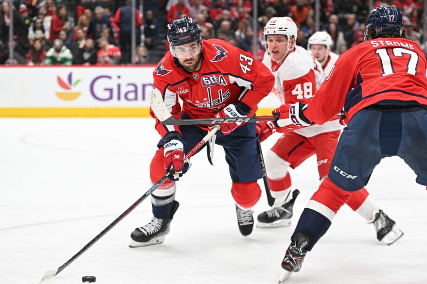 Washington Capitals right wing Tom Wilson (43) reaching for the puck during the second period of an NHL game against the Detroit Red Wings at Capital One Arena in Washington D.C., March 18, 2025. (Photo for the Washington Times)