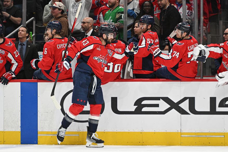 Washington Capitals right wing Tom Wilson (43) fist bumping teammates after scoring a goal during the third period of an NHL game against the Detroit Red Wings at Capital One Arena in Washington D.C., March 18, 2025. (Photo for the Washington Times)