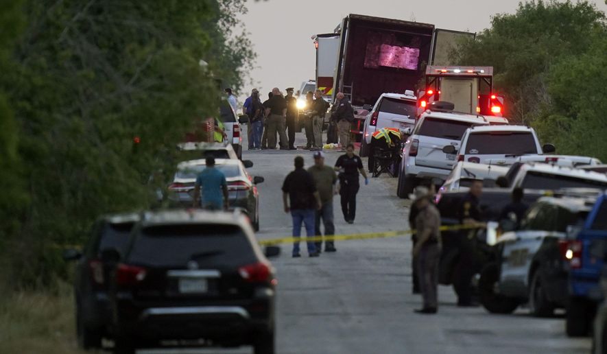 Police and other first responders work the scene where officials say dozens of people have been found dead and multiple others were taken to hospitals with heat-related illnesses after a tractor-trailer containing suspected migrants was found on June 27, 2022, in San Antonio, Texas. (AP Photo/Eric Gay, File)