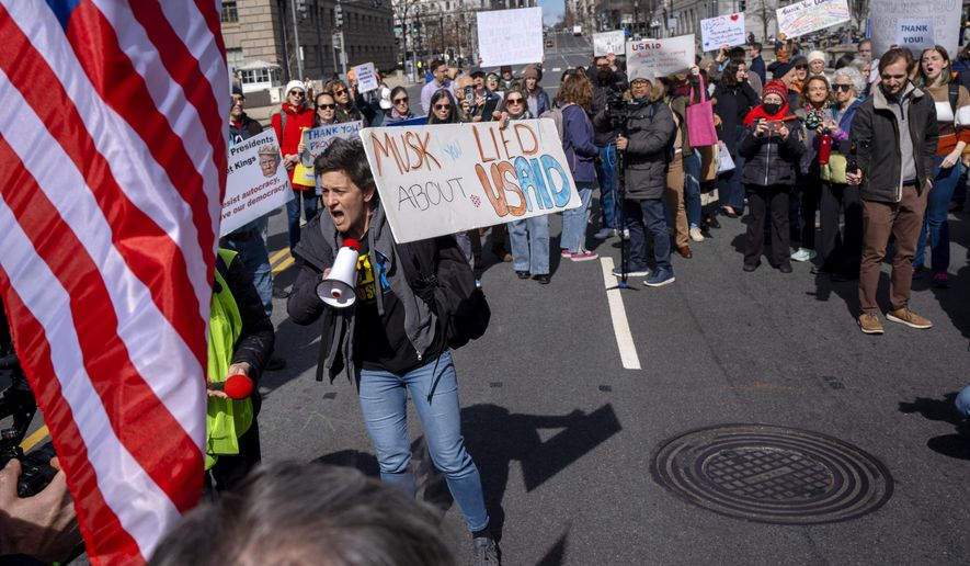 People rally on 14th St NW in support of fired USAID workers during a protest, Friday, Feb. 28, 2025, by the USAID headquarters in Washington. (AP Photo/Jacquelyn Martin) ** FILE **