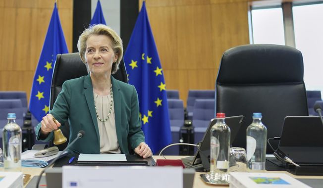 European Commission President Ursula von der Leyen rings a bell to signify the start of the weekly College of Commissioners meeting at EU headquarters in Brussels, Wednesday, March 19, 2025. (AP Photo/Virginia Mayo)