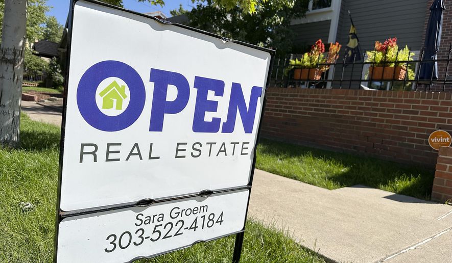 FILE - A sign stands outside a home for sale in the Alamo Placits neighborhood Tuesday, Aug. 27, 2024, in central Denver. (AP Photo/David Zalubowski, File)