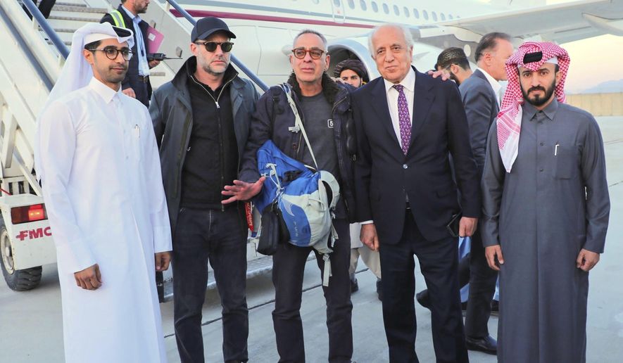 In this handout photo released by Qatar Ministry of Foreign Affairs, George Glezmann, center, poses with Adam Boehler, second left, and Zalmay Khalilzad, second right, and Qatari diplomats in Kabul, Afghanistan, Thursday, March 20, 2025, before departing to Doha, Qatar. (Qatar Ministry of Foreign Affairs via AP)
