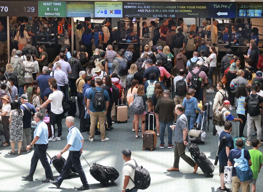 FILE - Travelers wait in line for security in the east hall atrium at Orlando International Airport, Thursday, May 25, 2023 in Orlando, Fla. (Joe Burbank /Orlando Sentinel via AP, File)