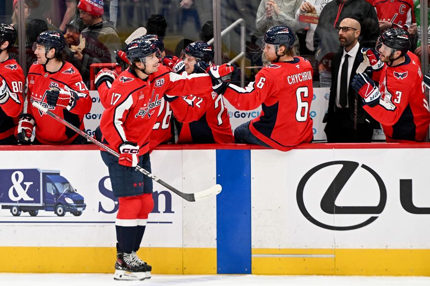 Washington Capitals center Dylan Strome (17) slapping hands with teammate Jakob Chychrun (6) after scoring a goal during the first period of an NHL game against the Detroit Red Wings at Capital One Arena in Washington D.C., March 18, 2025. (Photo for the Washington Times)
