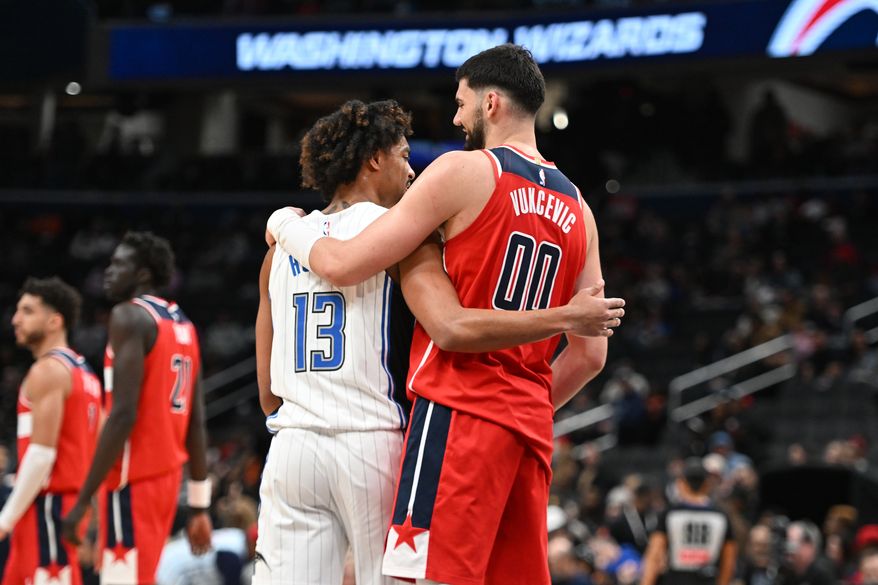 Washington Wizards forward Tristan Vukcevic (00) hugging Orlando Magic guard Jett Howard (13) after the Magic’s 120-105 win over the Wizards at Capital One Arena in Washington D.C., March 21, 2025. (Photo for the Washington Times)