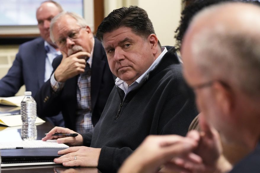 Illinois Gov. JB Pritzker listens to David Richardson, right, associate vice chancellor for research, during a visit to the Soybean Innovation Lab at University of Illinois, which is impacted by DOGE funding cuts, in Urbana, Ill., Wednesday, March 19, 2025. (AP Photo/Nam Y. Huh)