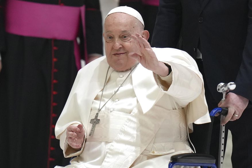 FILE - Pope Francis waves as he arrives for his weekly general audience in the Paul VI Hall, at the Vatican, Wednesday, Feb. 12, 2025. (AP Photo/Alessandra Tarantino, File)