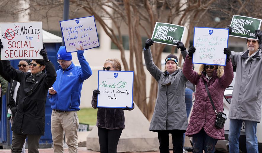 FILE - Demonstrators gather outside of the Edward A. Garmatz United States District Courthouse in Baltimore, on Friday, March 14, 2025, before a hearing regarding the Department of Government Efficiency's access to Social Security data. (AP Photo/Stephanie Scarbrough, File)