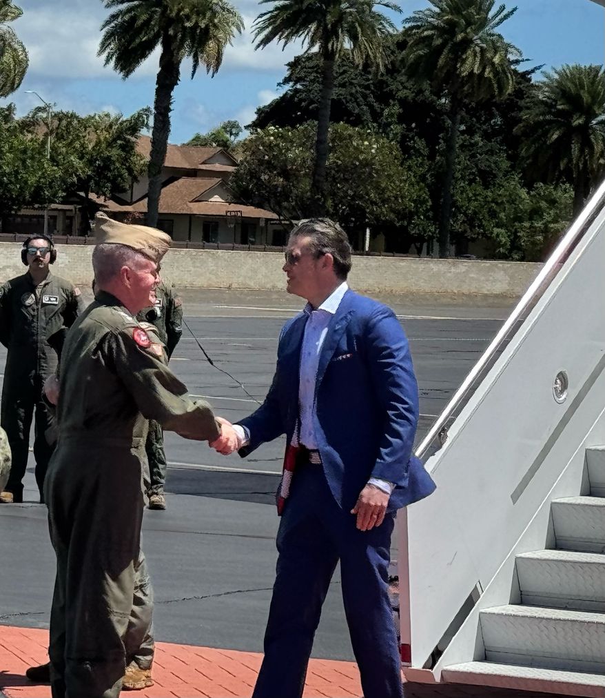 Adm. Sam Paparo, Indo Pacific Command chief, greets Defense Secretary Pete Hegseth at command headquarters in Hawaii, where Mr. Hegseth stopped over on his way to the Philippines and Japan for his first Asia trip. (Bill Gertz/The Washington Times)