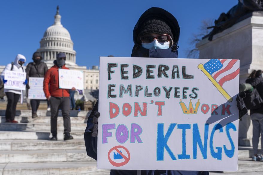 A federal employee, who asked not to use their name for fear of losing their job, protests with a sign saying "Federal Employees Don't Work for Kings" during the "No Kings Day" protest on Presidents Day, on Feb. 17, 2025, near the Capitol in Washington. (AP Photo/Jacquelyn Martin) **FILE**