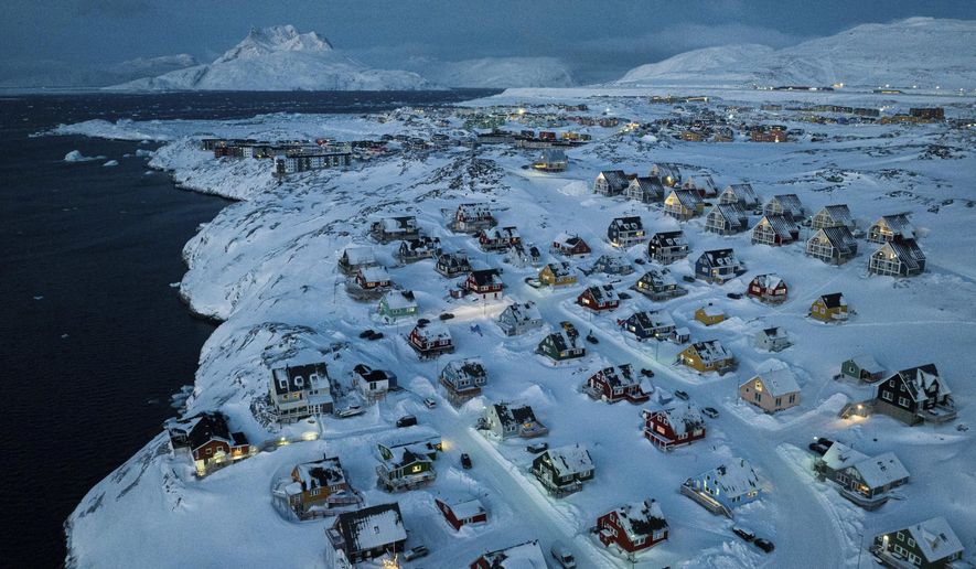 Houses covered by snow are seen on the coast of a sea inlet at Nuuk, Greenland, Friday, March 7, 2025. (AP Photo/Evgeniy Maloletka)
