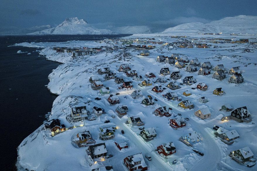 Houses covered by snow are seen on the coast of a sea inlet at Nuuk, Greenland, Friday, March 7, 2025. (AP Photo/Evgeniy Maloletka)