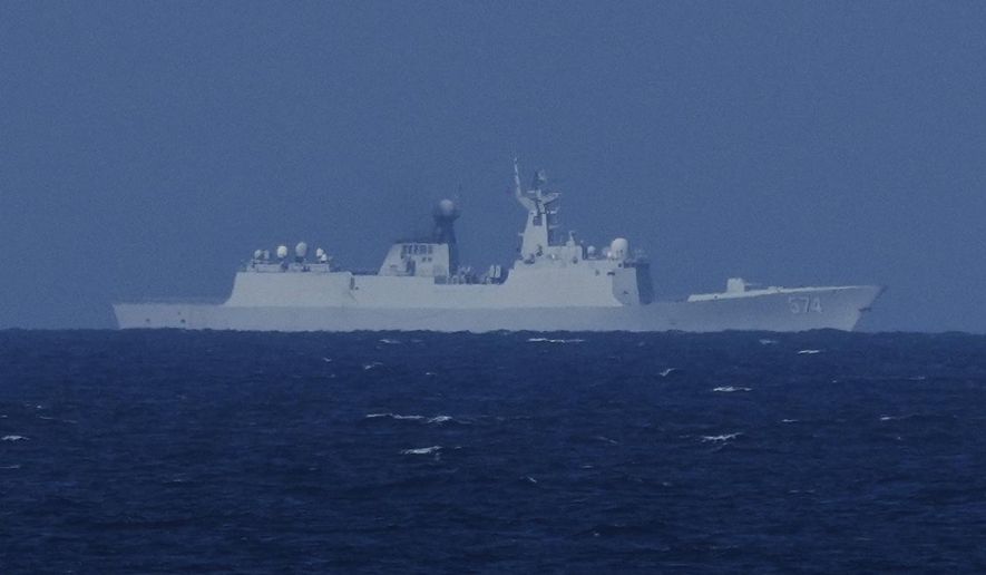 A China Navy Ship with bow number 574 observes the Philippines United States Japan Multilateral Maritime Cooperative Activity off a disputed South China Sea shoal on Friday, March 28, 2025. (AP Photo/Aaron Favila)