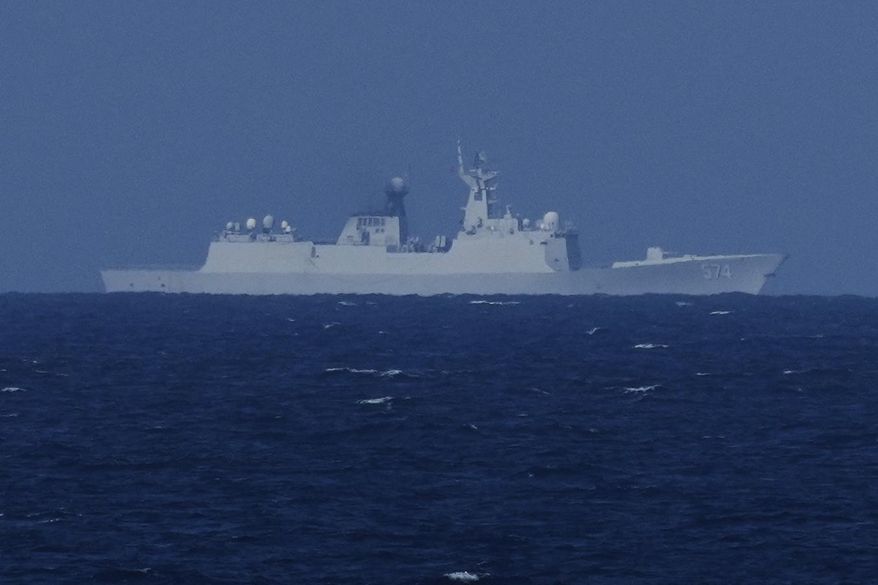 A China Navy Ship with bow number 574 observes the Philippines United States Japan Multilateral Maritime Cooperative Activity off a disputed South China Sea shoal on Friday, March 28, 2025. (AP Photo/Aaron Favila)